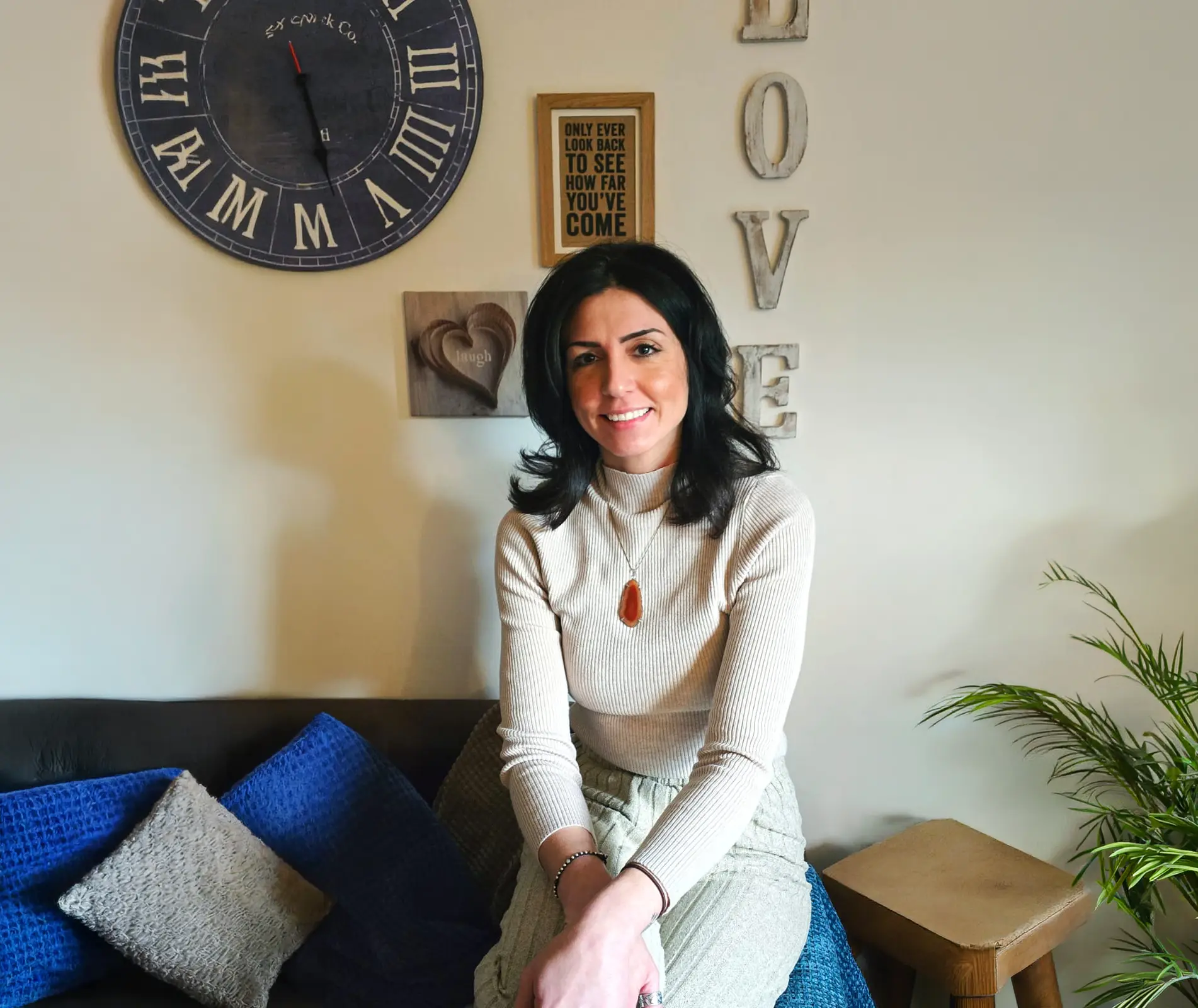 Sophie, Reiki and relaxation therapist, smiling warmly at home